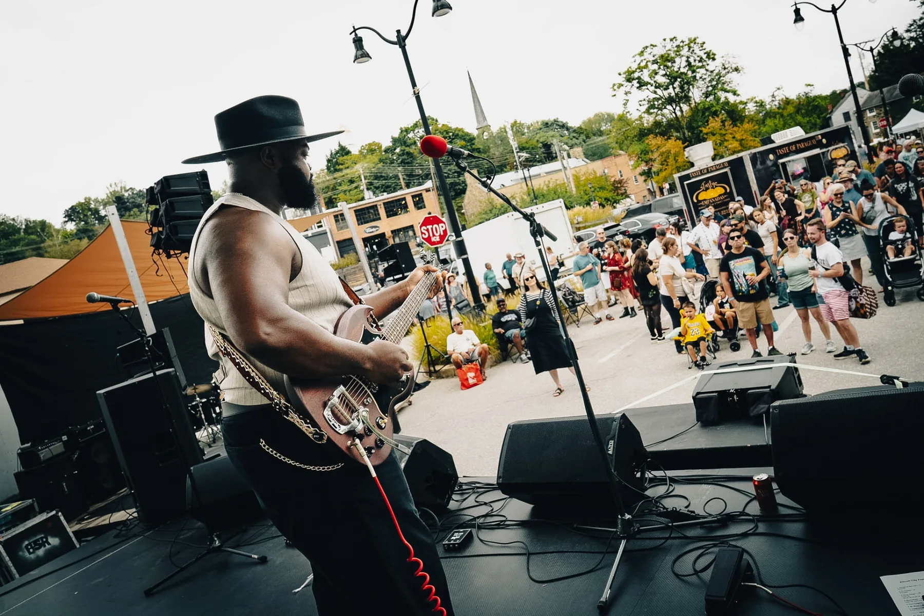 Cuppa T Jones performing onstage in front of a festival crowd.
